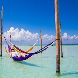 Woman resting at Caribbean beach hammock